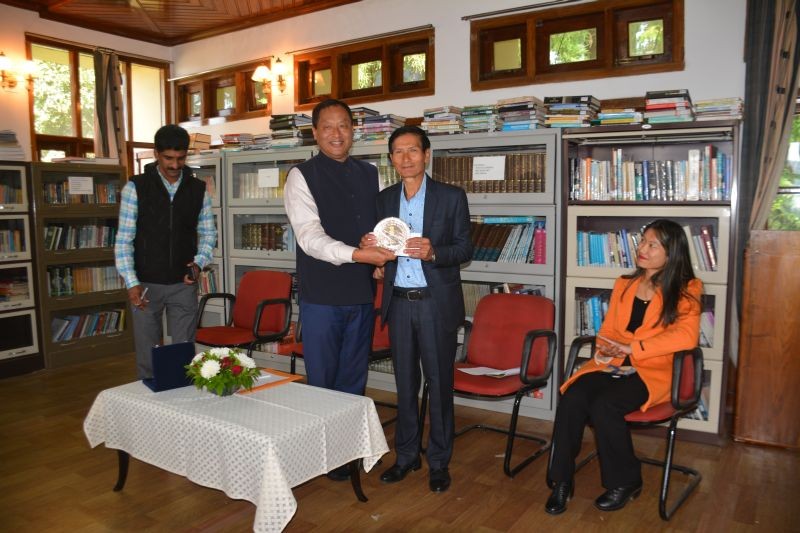 Commissioner & Secretary to Governor, T Mhabemo Yanthan IAS presenting a memento to the retiring Additional Secretary, Tali Moa Changkiri. (Photo Courtesy: PRO Raj Bhavan)